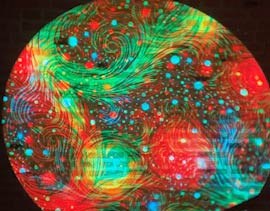 Video: swirling multicolor psychedelic pattern washing over a wall for ambient effect