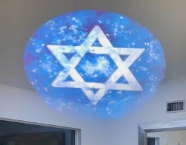 Video: Star of David on a starry blue field projected across a living room ceiling