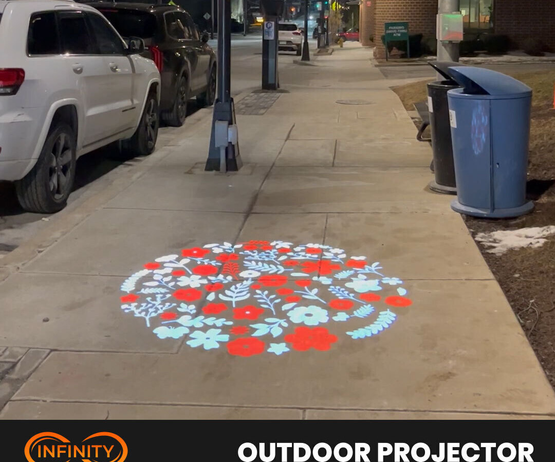 Video: red and white floral medallion brightening a city sidewalk beside parked cars