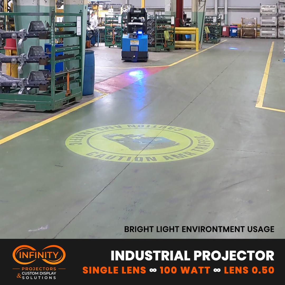 Video: yellow caution safety sign projected on a factory aisle floor as an automated forklift approaches — Infinity Projectors