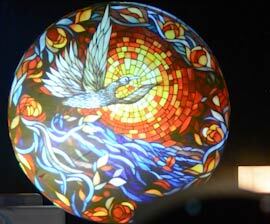 Video: stained-glass style dove mosaic circle projected on a dark wall