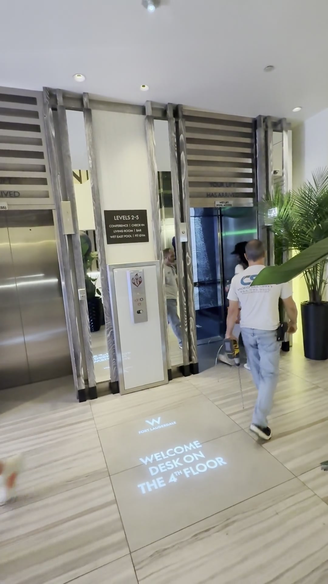 W Hotel Fort Lauderdale wayfinding text projected on the elevator lobby floor guiding guests to the 4th floor welcome desk — Infinity Projectors