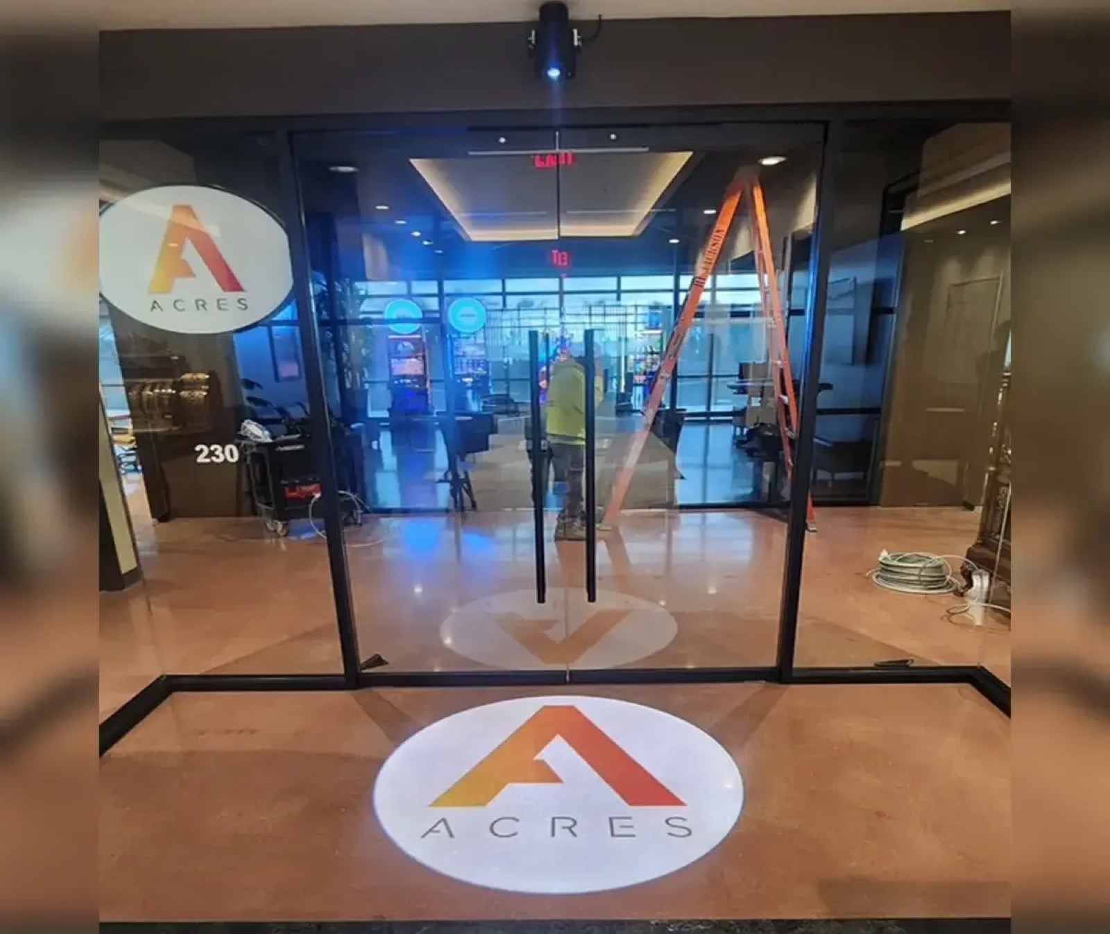 Real Acres Triangle Logo Glass Entrance logo gobo projection — real Business & Branding install | Infinity Projectors — Infinity Projectors