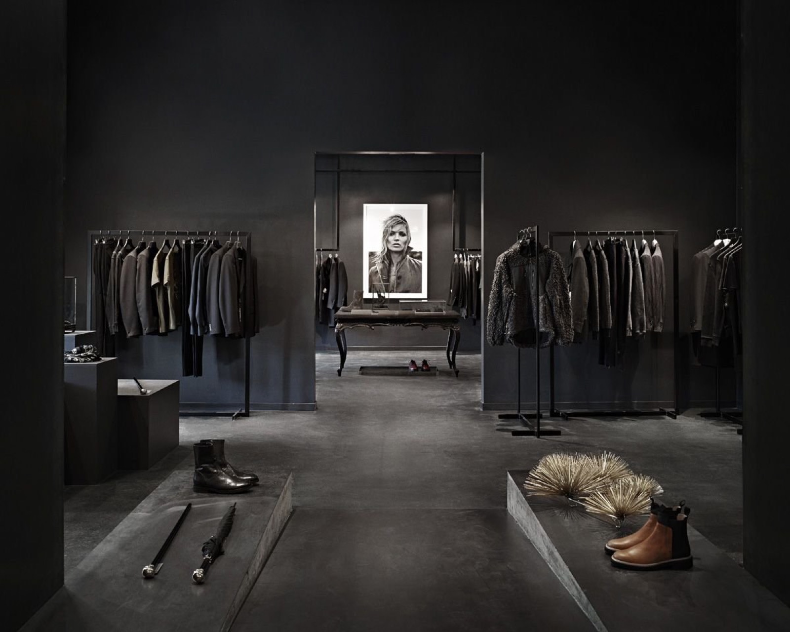 Dark-walled clothing store interior — an example of a space a logo projection can light. No projection in this photo and not a customer install. | Infinity Projectors