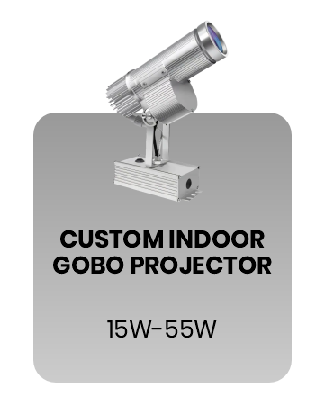 Custom indoor gobo projector, silver body, 3/4 view, on a grey rounded card labeled 'Custom Indoor Gobo Projector, 15W-55W' — Infinity Projectors