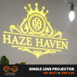 Video: gold crowned lounge monogram logo gobo glowing on a white interior wall
