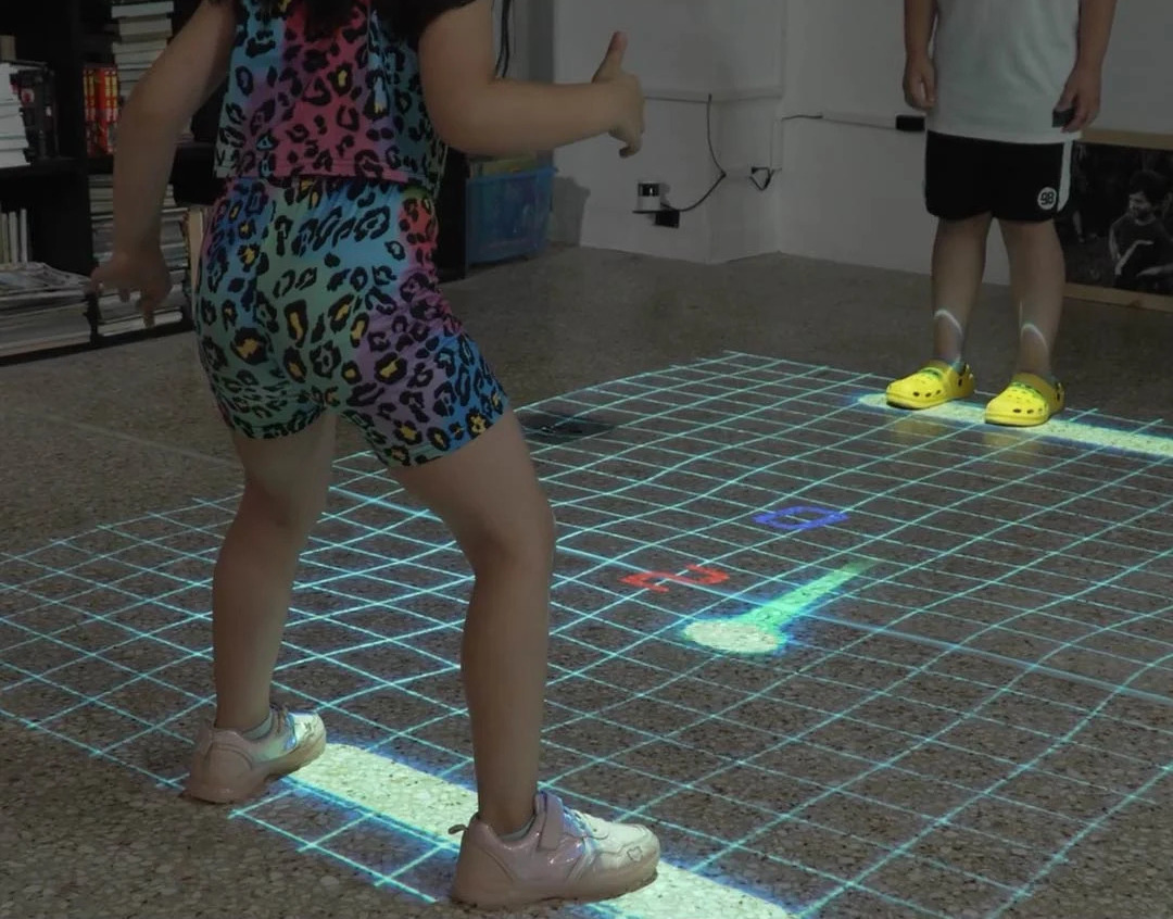 real photo of kids on interactive floor grid — Infinity Projectors