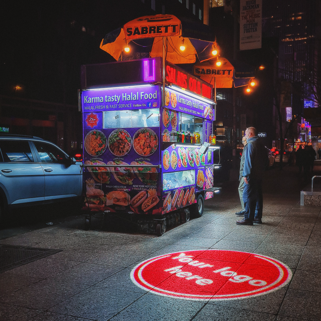 real nighttime street photo with food cart and floor logo — Infinity Projectors
