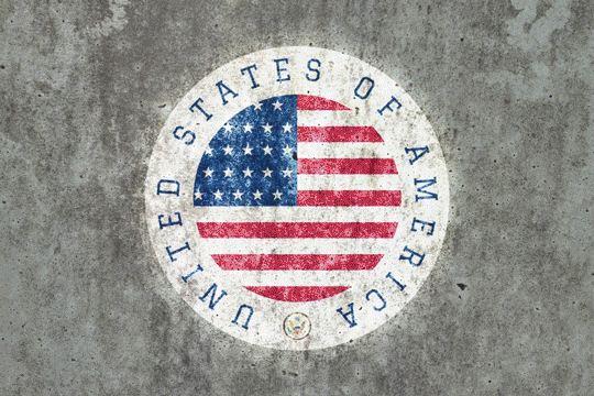 Real photo of American flag circle logo projected on stone wall — Infinity Projectors