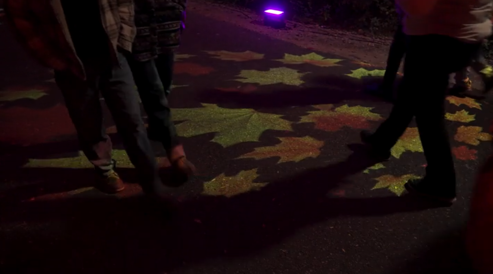 real dim photo of pattern on floor with feet visible — Infinity Projectors