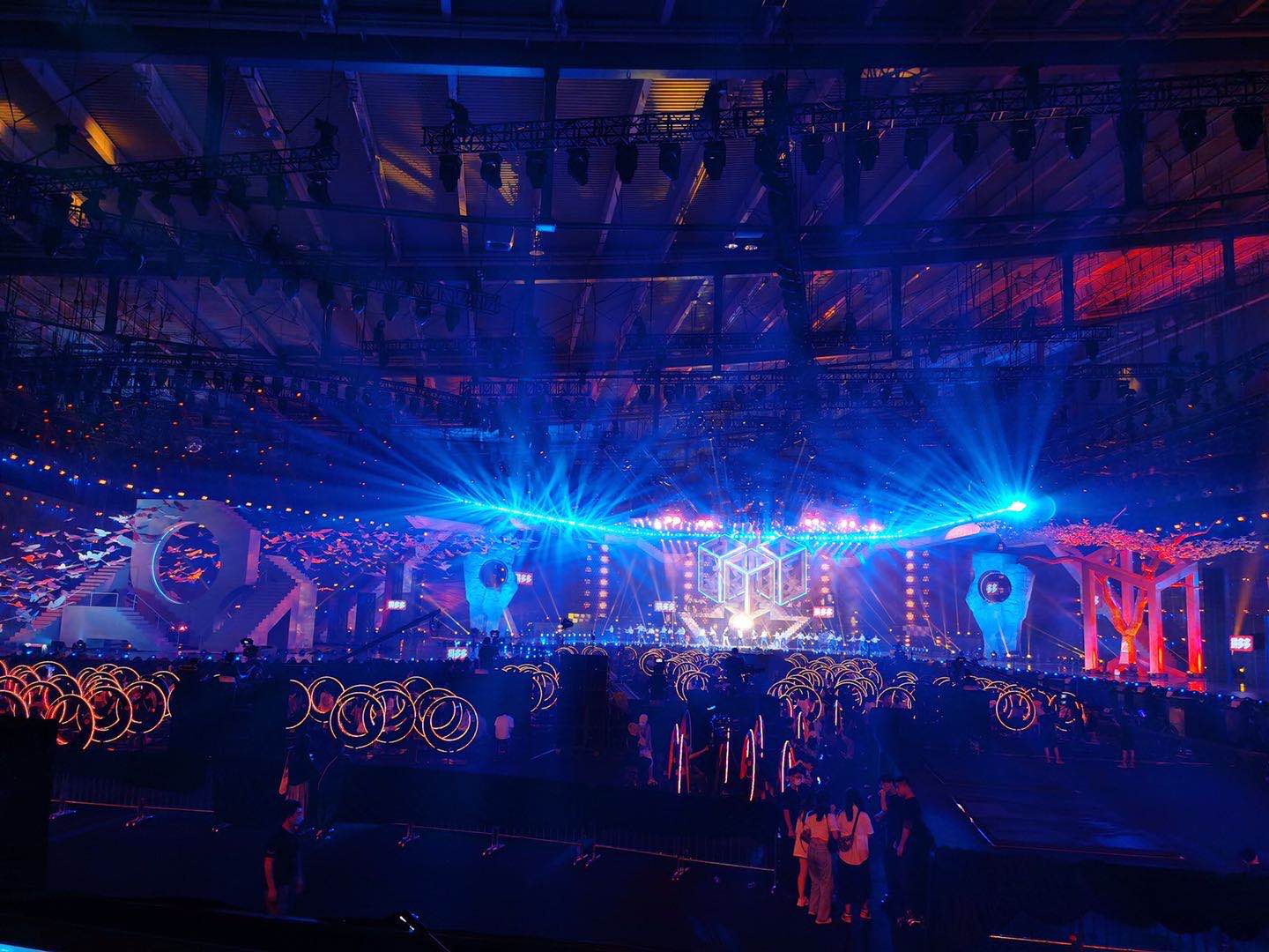 real photo of concert/event with blue stage lighting — Infinity Projectors