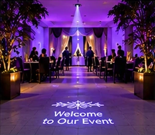 Event room lit purple with Welcome to Our Event projected on the floor at the entrance — Infinity Projectors