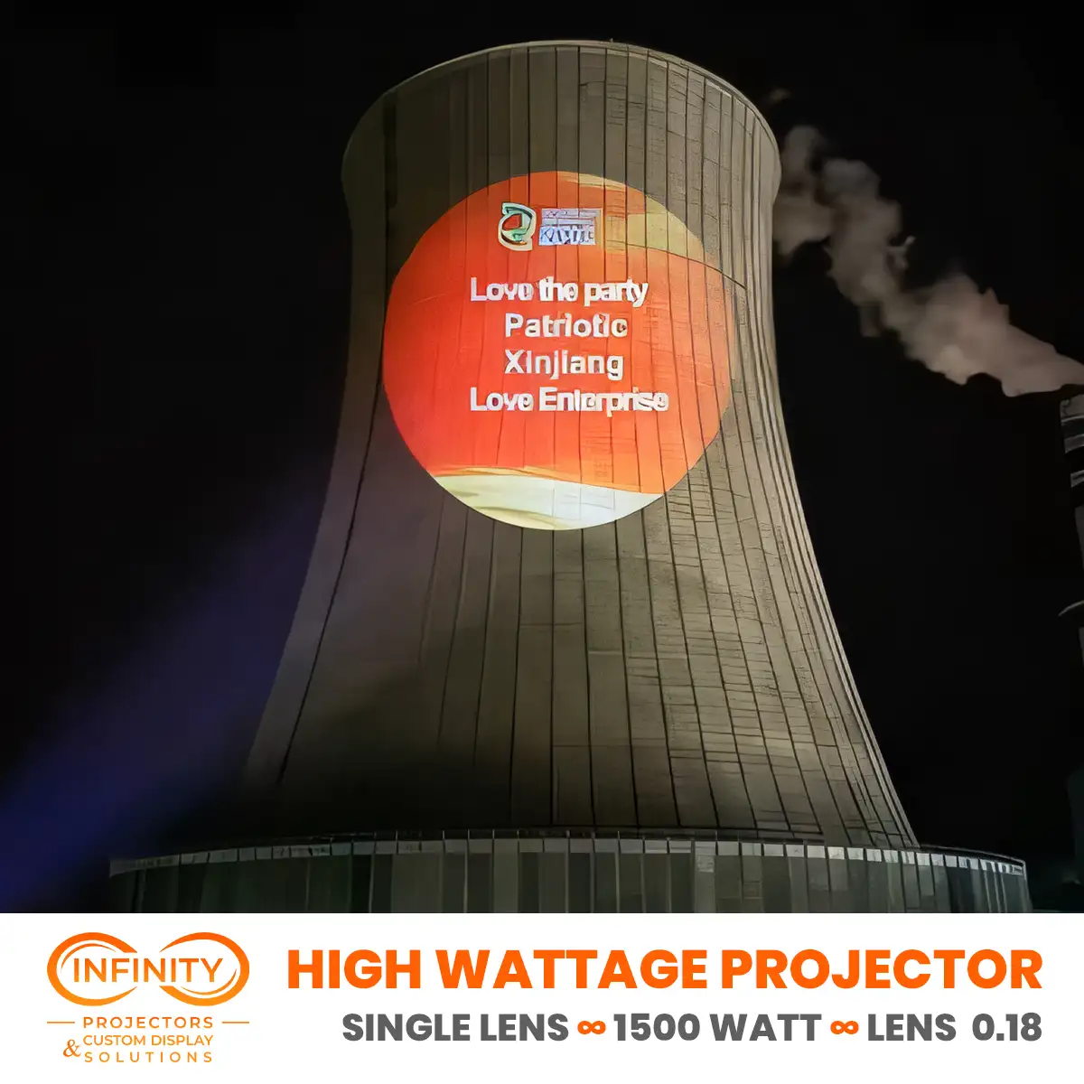 Orange circle of patriotic slogans lighting up a power plant cooling tower at night from a high wattage projector