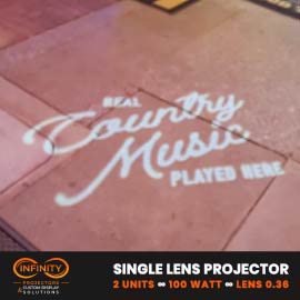 Video: white script sign about live country music projected across brick patio pavers