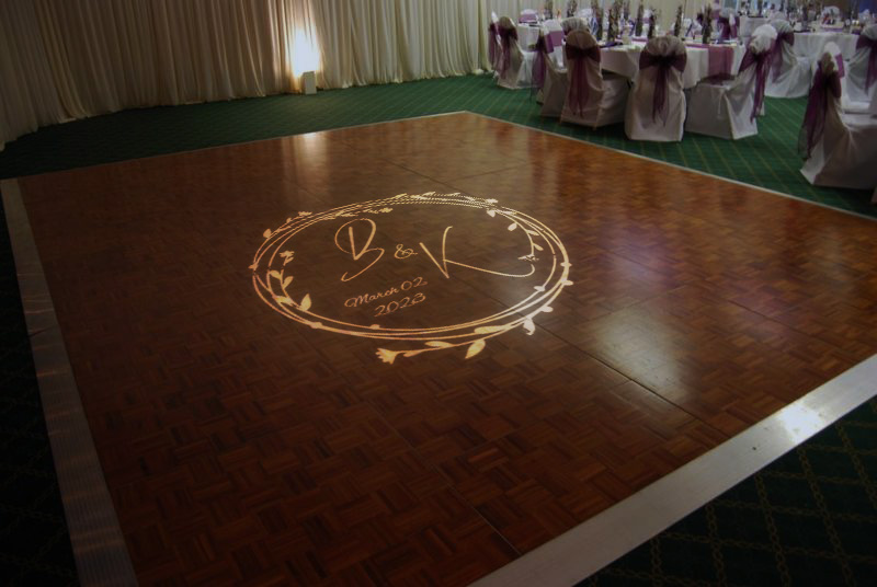 real photo of monogram on wood dance floor — Infinity Projectors