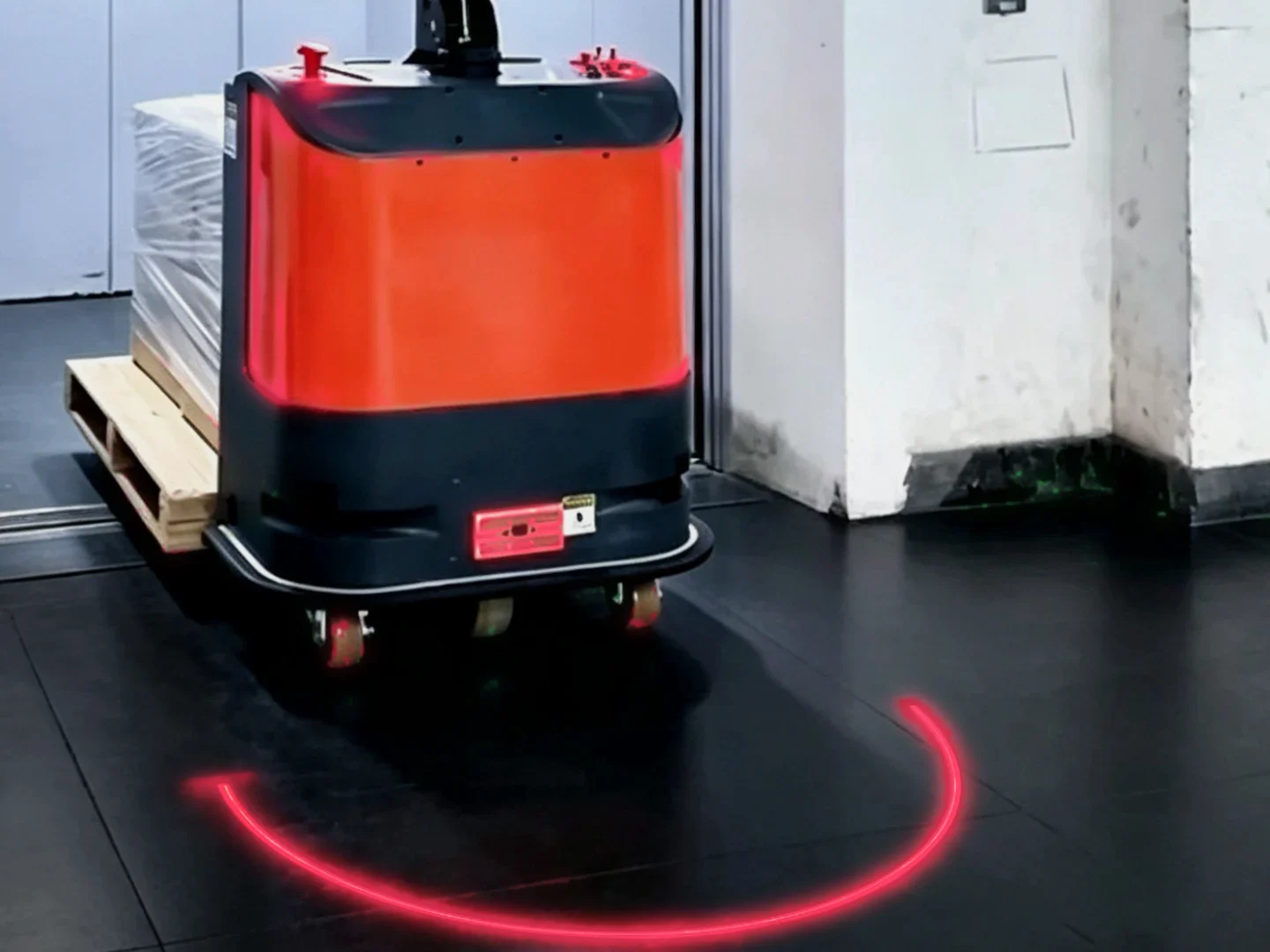 A red laser arch on the floor in front of an autonomous pallet truck — Infinity Projectors