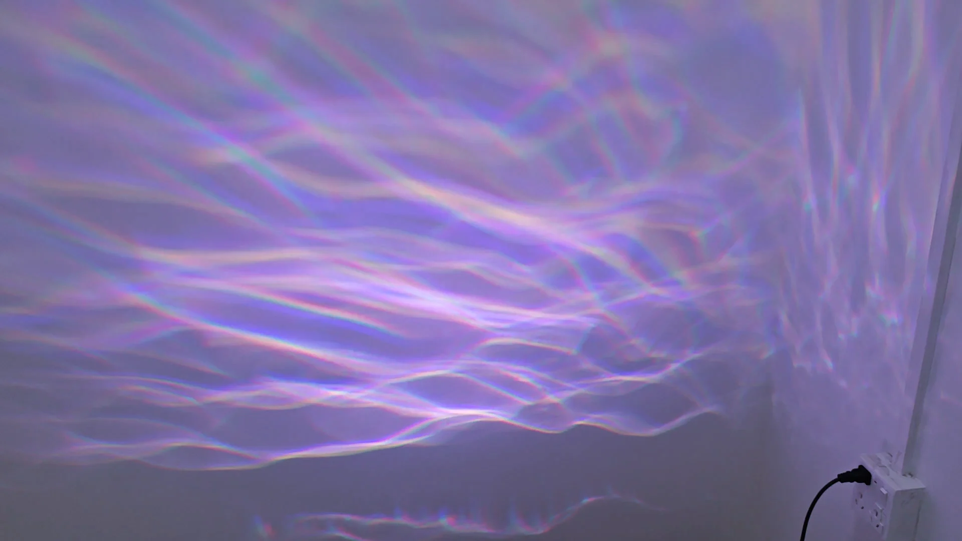 Soft violet and white aurora water waves moving across a white wall indoors — Infinity Projectors