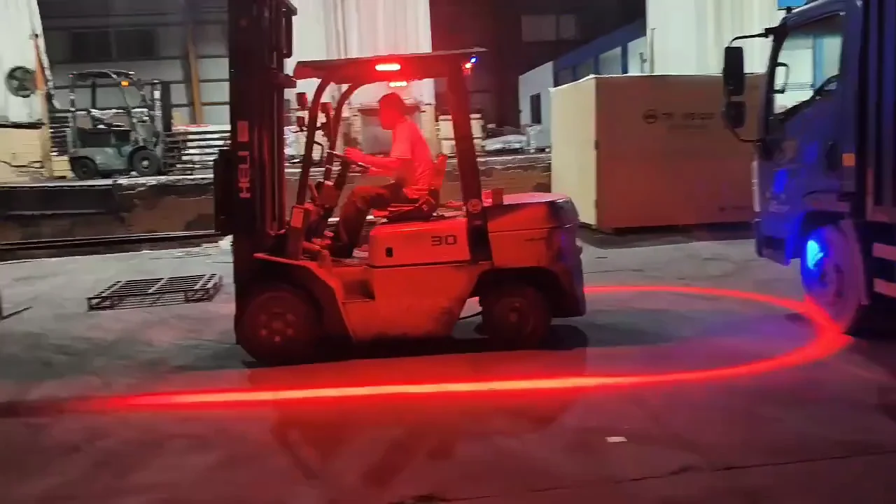 Forklift in a yard at night projecting a red LED arc on the floor around its rear — Infinity Projectors