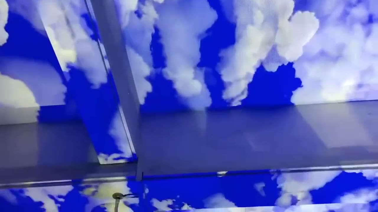 Cloud Projector drifting white clouds and doves across a blue ceiling and feature wall — Infinity Projectors