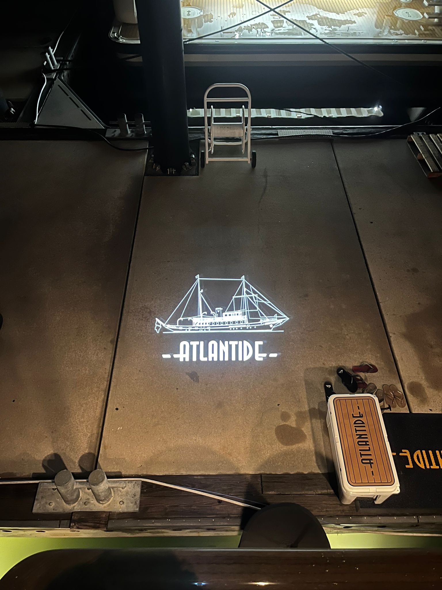real photo of text projected on dock/pier ground — Infinity Projectors