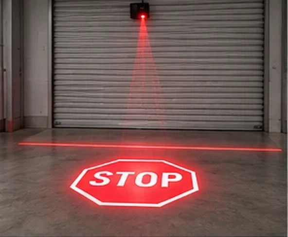 Red STOP sign projected on the floor at a roller shutter door — Infinity Projectors
