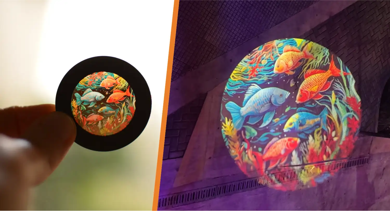 Full-color tropical fish gobo and its circular projection glowing on a purple-lit brick wall