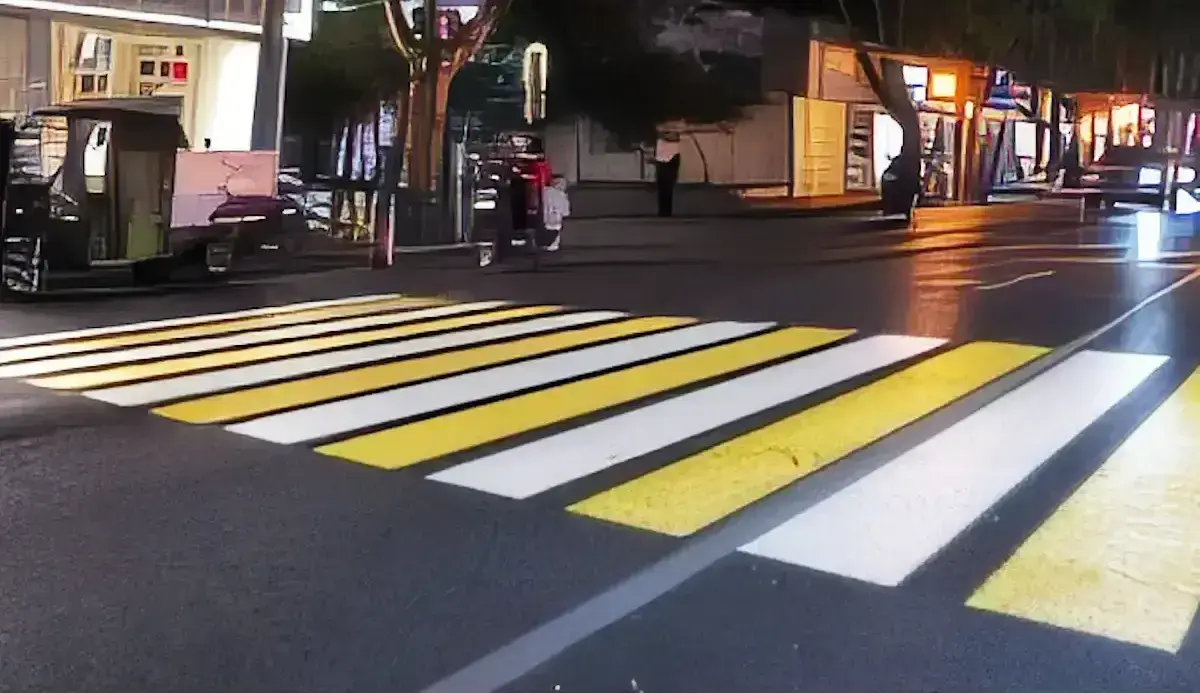 Glowing virtual crosswalk stripes projected on a night street, a high-visibility outdoor floor projection — Infinity Projectors