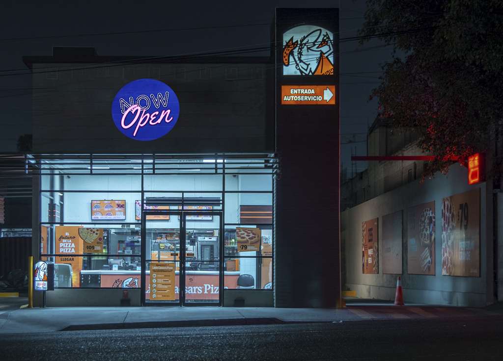real photo of tiger logo projected on storefront at night — Infinity Projectors