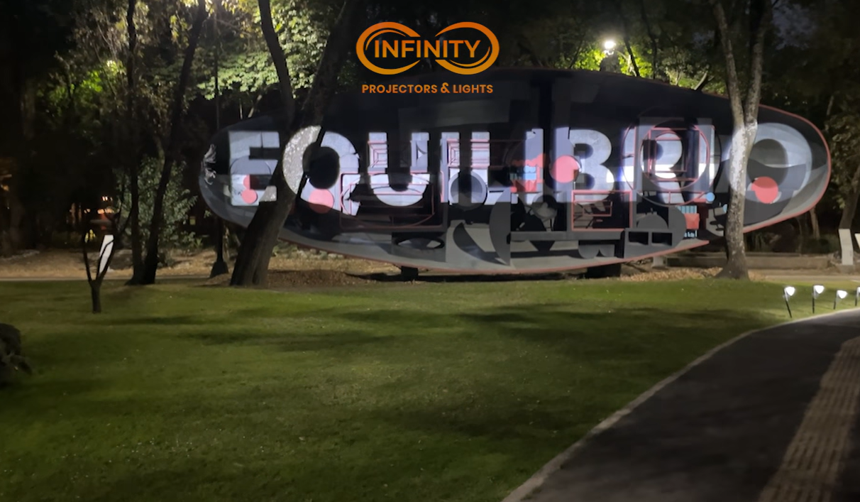 real photo of text projected on outdoor grass field — Infinity Projectors