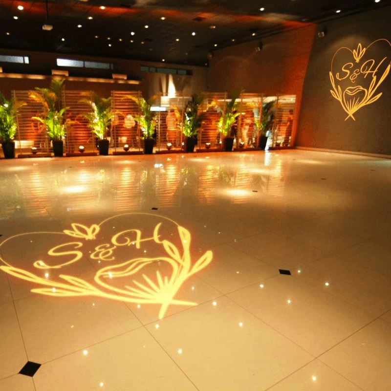 real photo of golden text/floral design projected on ballroom floor — Infinity Projectors