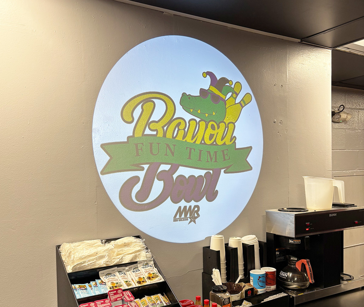 Real photo of logo projected indoors with spec banner — Infinity Projectors