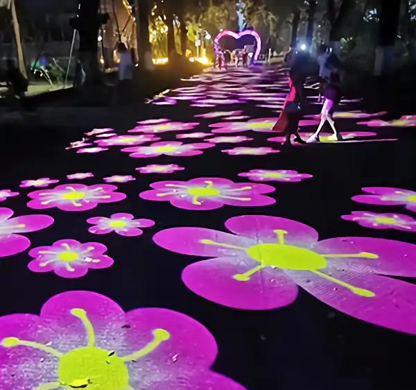 Real photo of purple flower pattern projected in park at night — Infinity Projectors