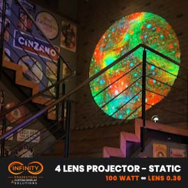 Video: swirling orange-green lava texture circle glows on a brick wall beside a bar staircase